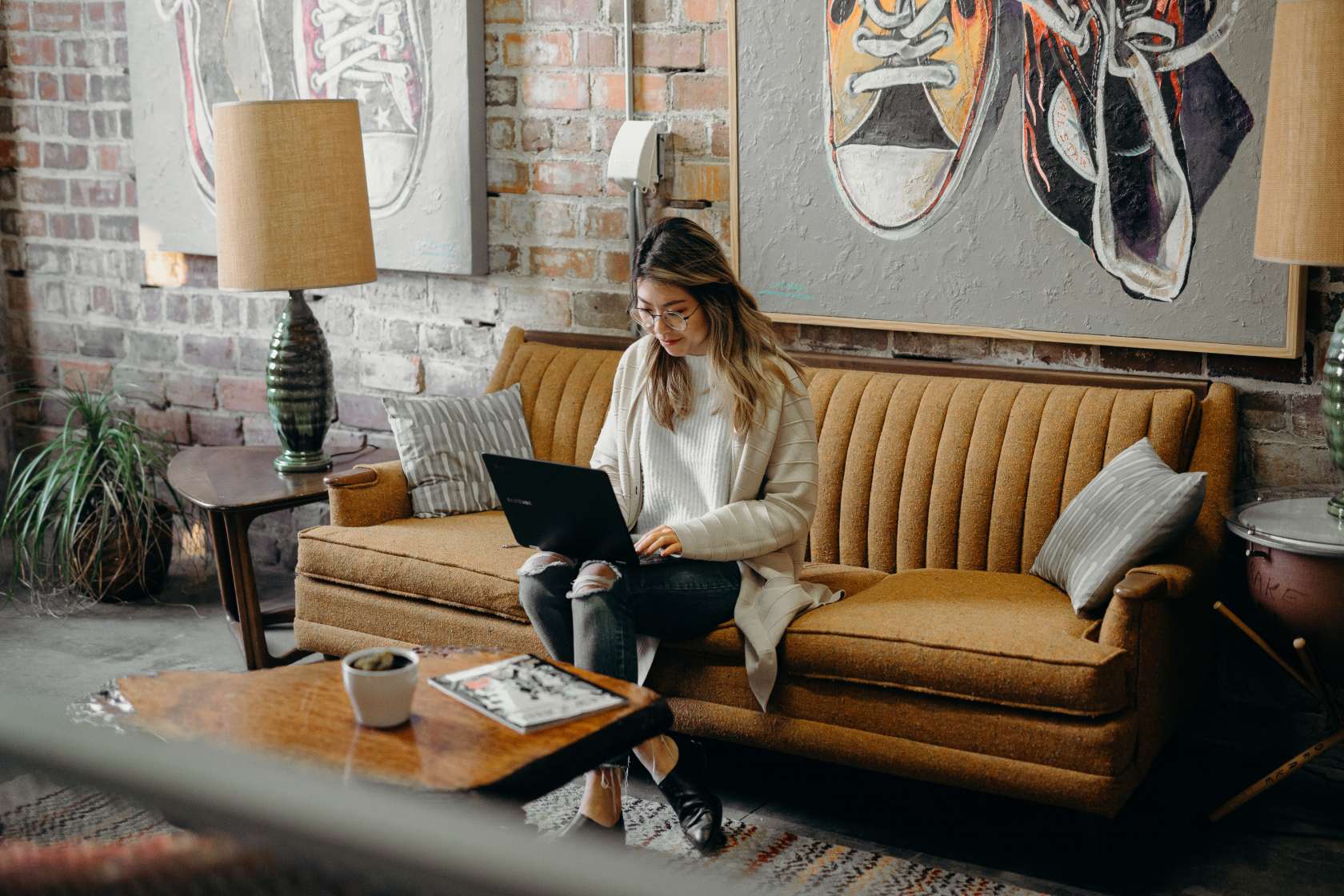 aapi month - image of a woman on a sofa with a laptop