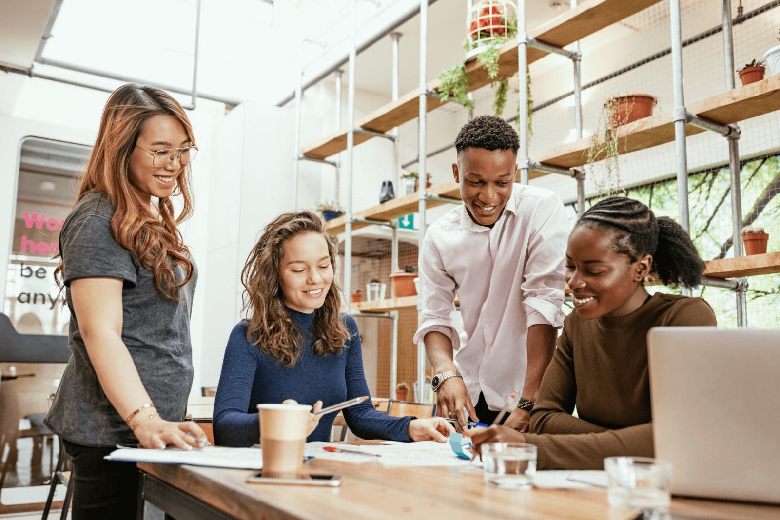 diverse busines team collaborates on project around desk
