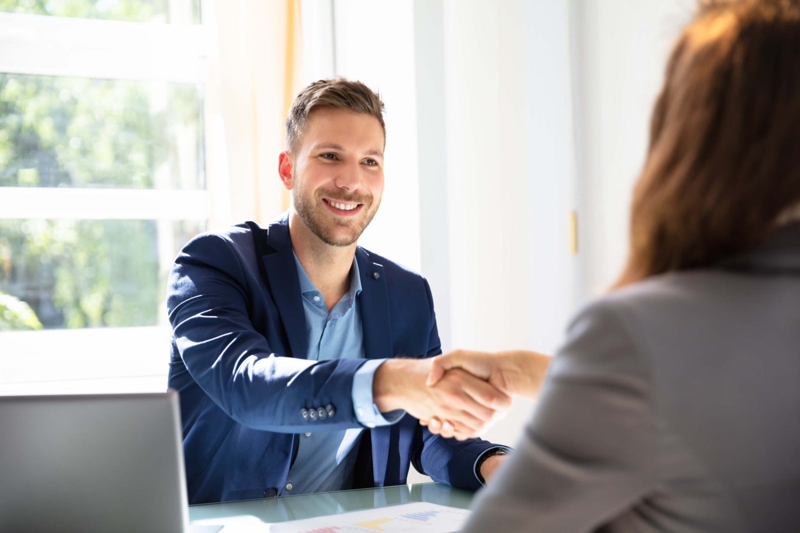 hiring manager and job candidate shake hands