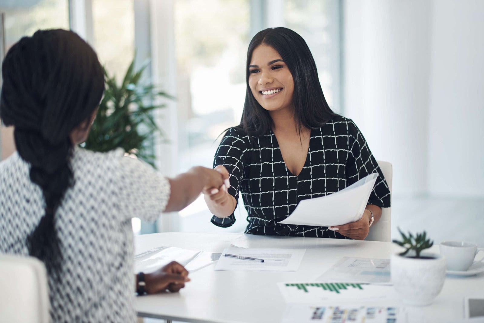interviewer greets job candidate at start of interview
