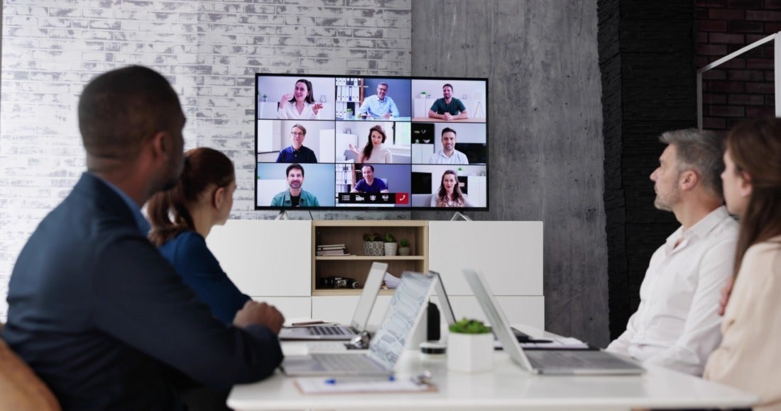 Professionals at in a Conference Room Attending a Virtual Meeting