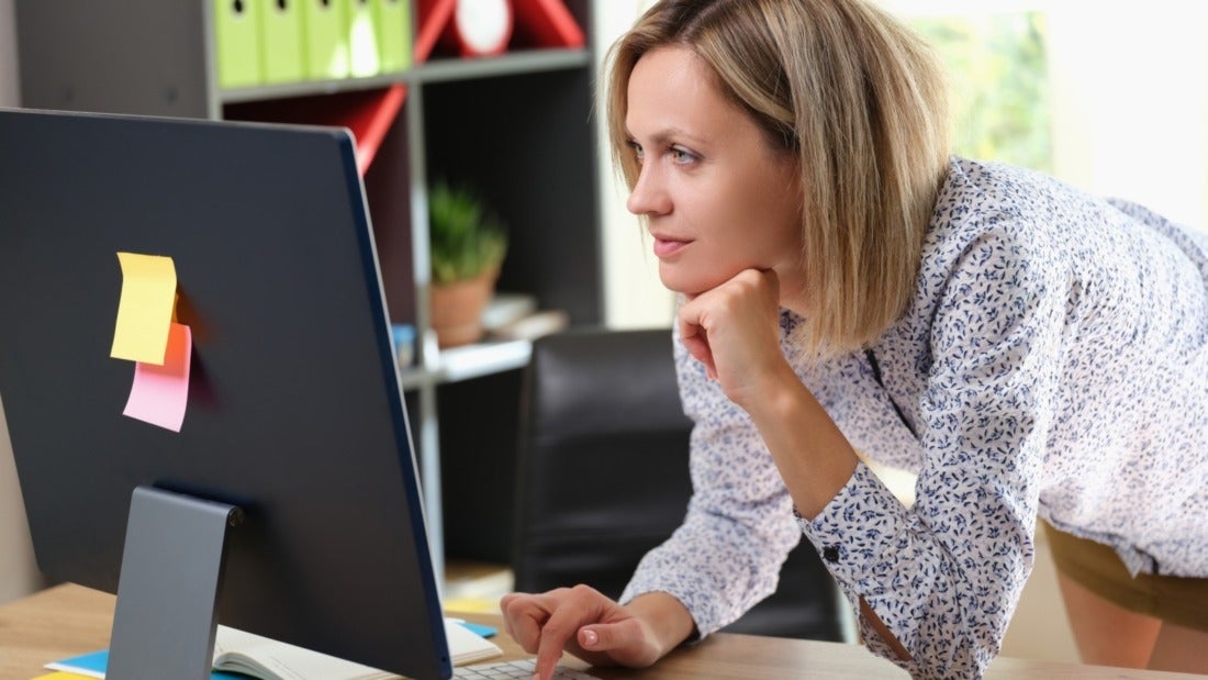 Female Worker Reading Intently on Computer Screen
