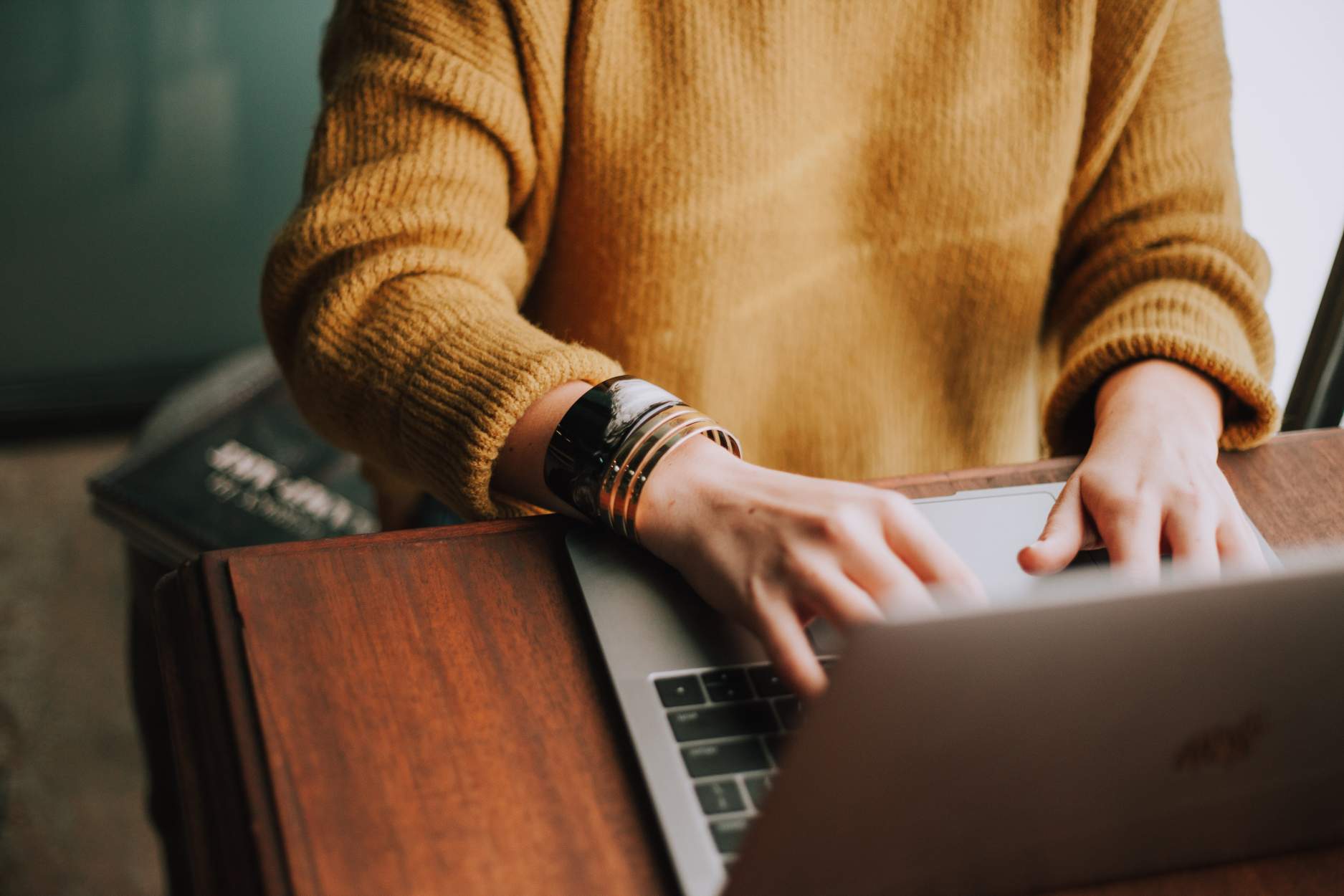 person writing a job description on a laptop