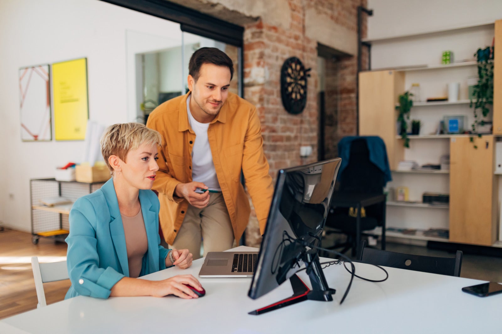Colleagues working together on a computer