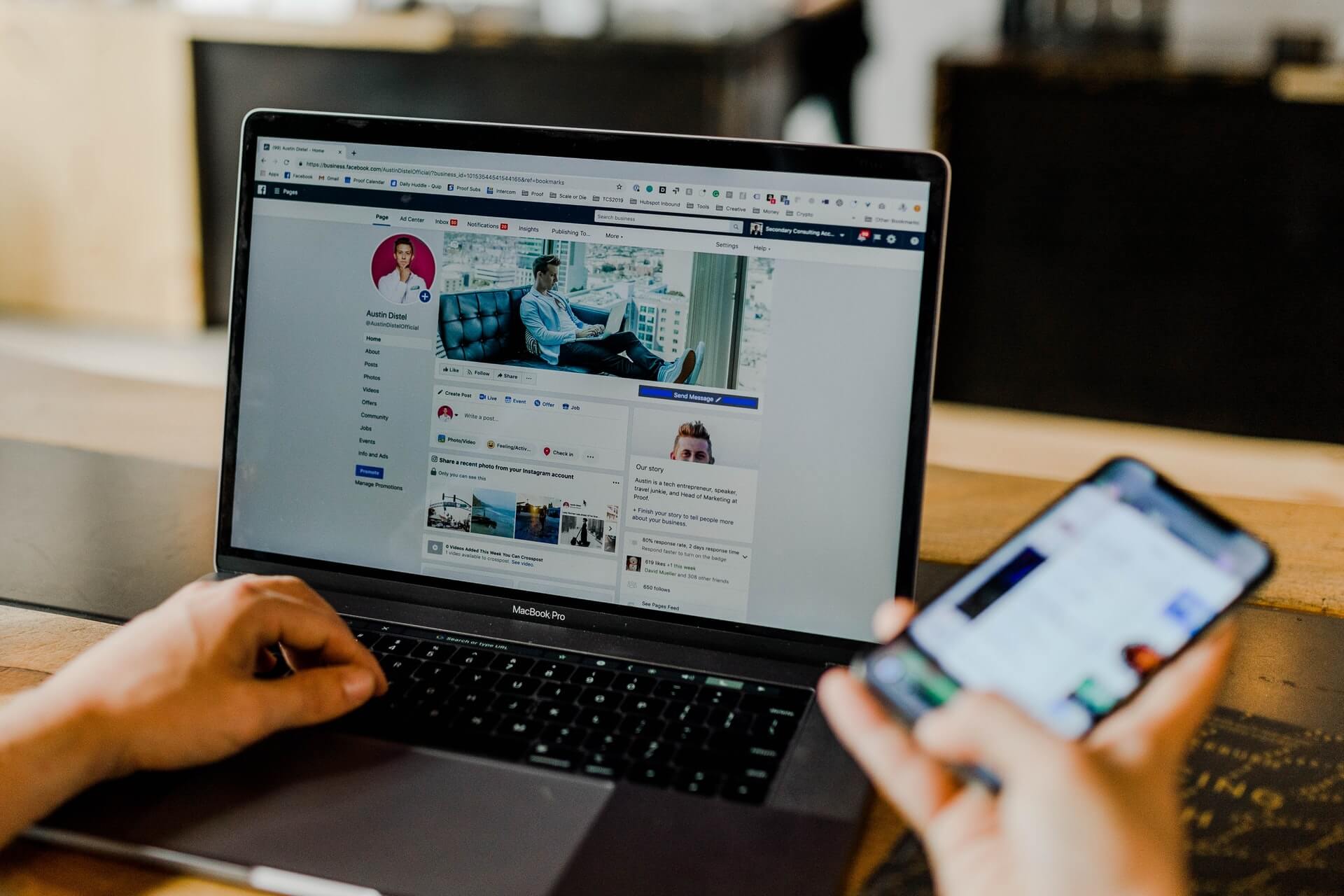 Image shows computer monitor with social media profile and someone using social media on phone