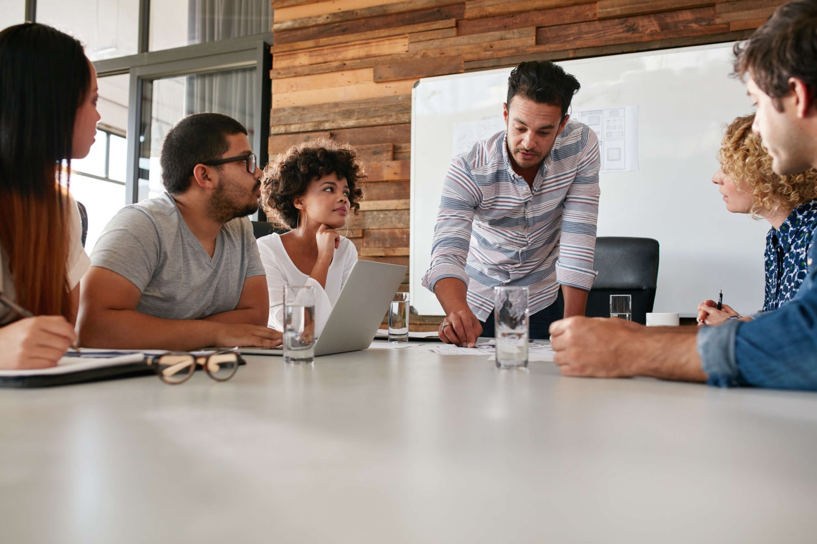 young business leader presents in front of employees